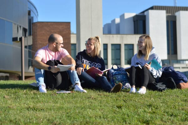 SUNY Niagara students sitting in front of campus