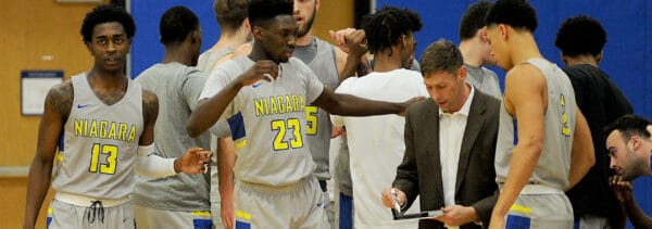 head coach giving instruction to basketball team