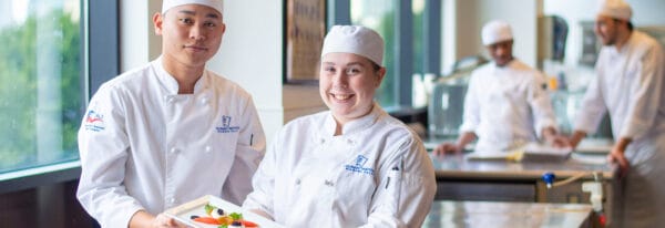 Culinary students presenting a dish