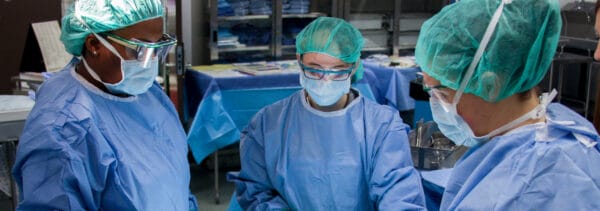 Students in medical scrubs working in a lab