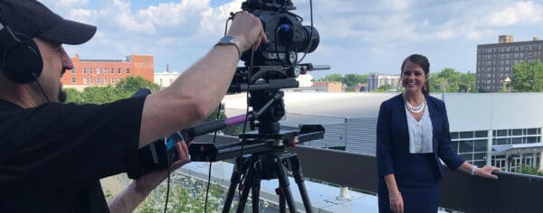 Woman being video recorded by a cameraman