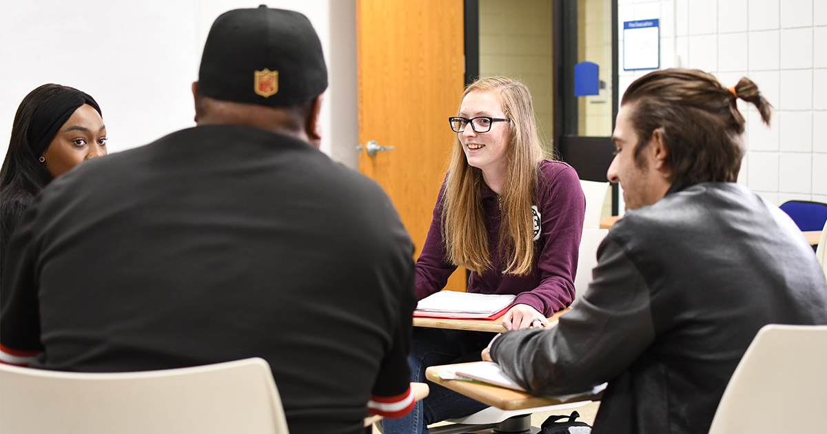 students talking in a classroom