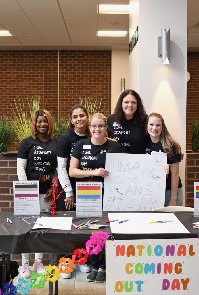 Each October, the Pride Alliance Club hosts a, “National Coming Out Day” event where students and employees can sign the ally pledge and purchase “National Coming Out Day” shirts.