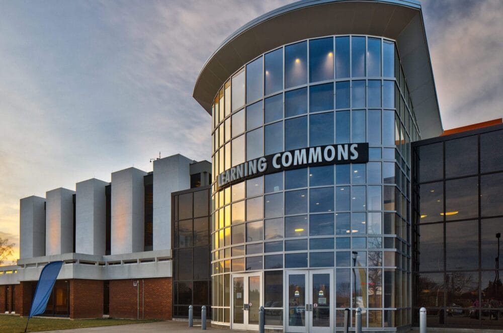 SUNY Niagara Learning Commons Photo during sunset with the sun reflecting off of the windows