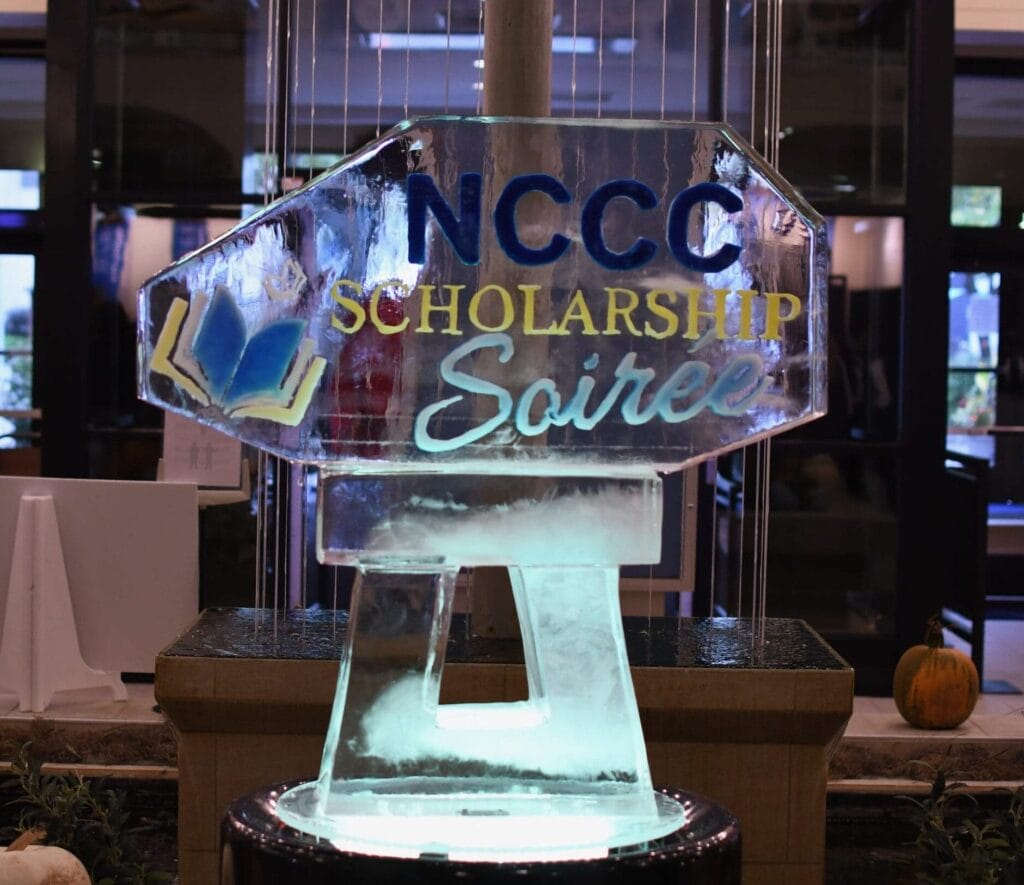 NCCC Scholarship ice Soiree Sculpture in front of a waterfall at the Niagara Falls Culinary Institute.