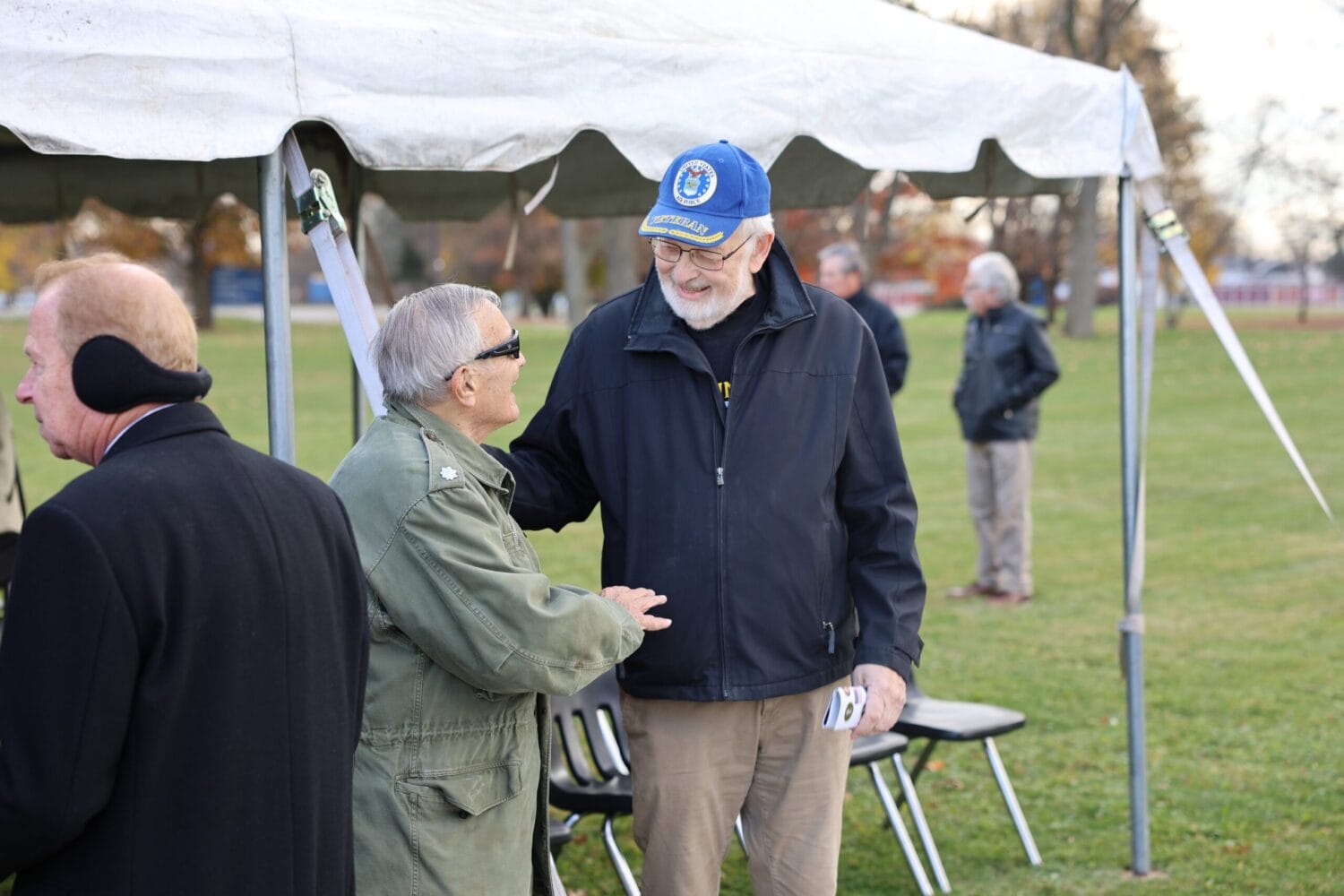 Veteran speaking with SUNY Niagara Trustee at Veterans Day Ceremony