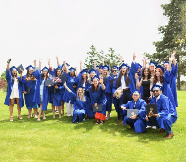 Group of students cheering and celebrating after Commencement