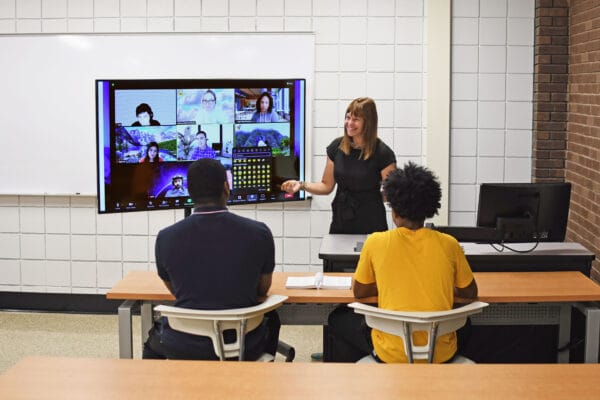 Faculty member teaching in hyflex classroom