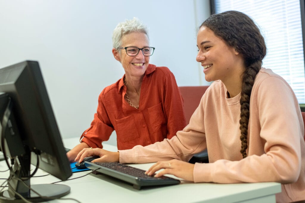 Staff providing accessibility services to student in testing center