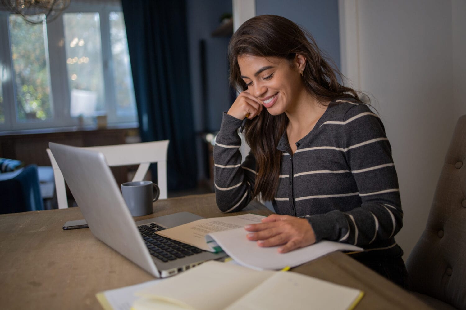 Student taking class on laptop at home