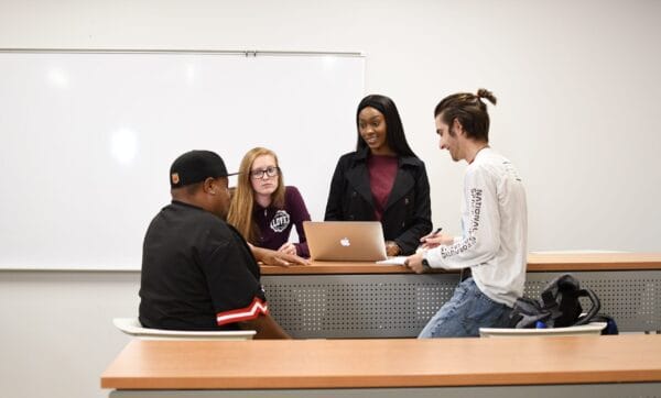 Group of students studying together in a classroom