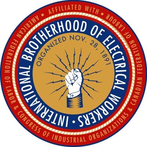Circular logo for the International Brotherhood of Electrical Workers, featuring a raised fist with lightning bolts, surrounded by text about its affiliation and its founding date, November 28, 1891.