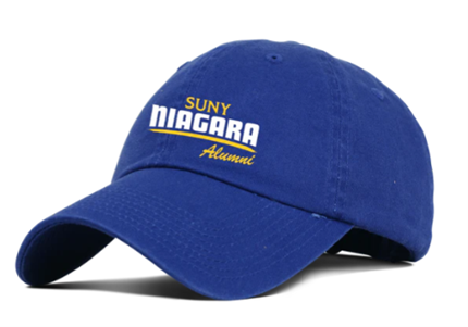 A royal blue baseball cap with SUNY NIAGARA Alumni embroidered in white and yellow letters on the front. The cap has a curved brim and a relaxed, unstructured fit.
